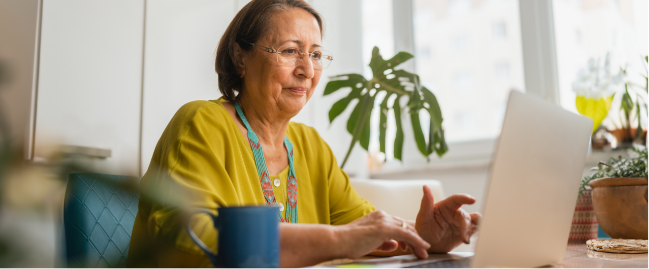 older adult using a laptop